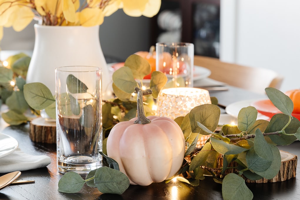 pink ombre pumpkin in faux eucalyptus on thanksgiving table decor