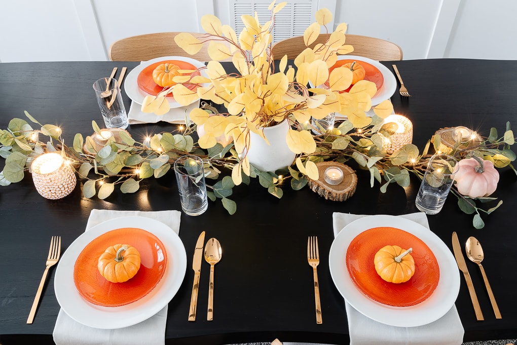 overhead view of modern thanksgiving table on black wooden table