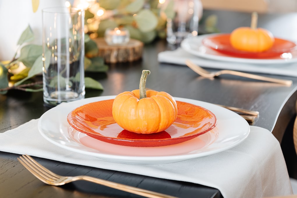 mini orange pumpkin on orange salad plate