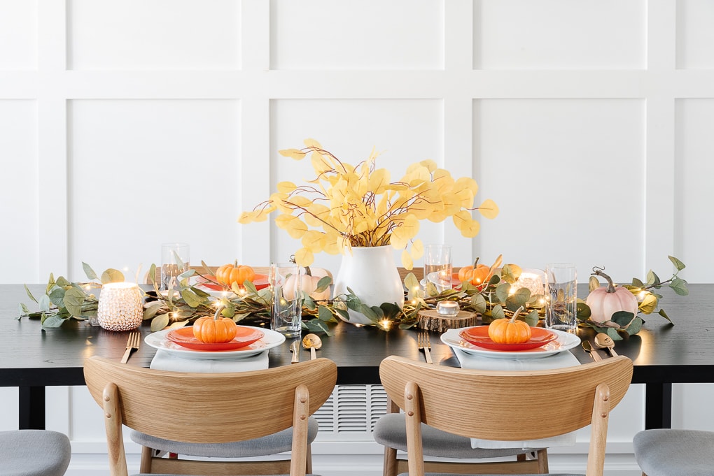 modern thanksgiving table decor with eucalyptus and white vase centerpiece