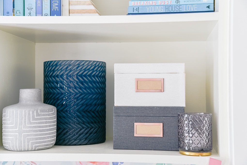 winter votive candle on bookshelf