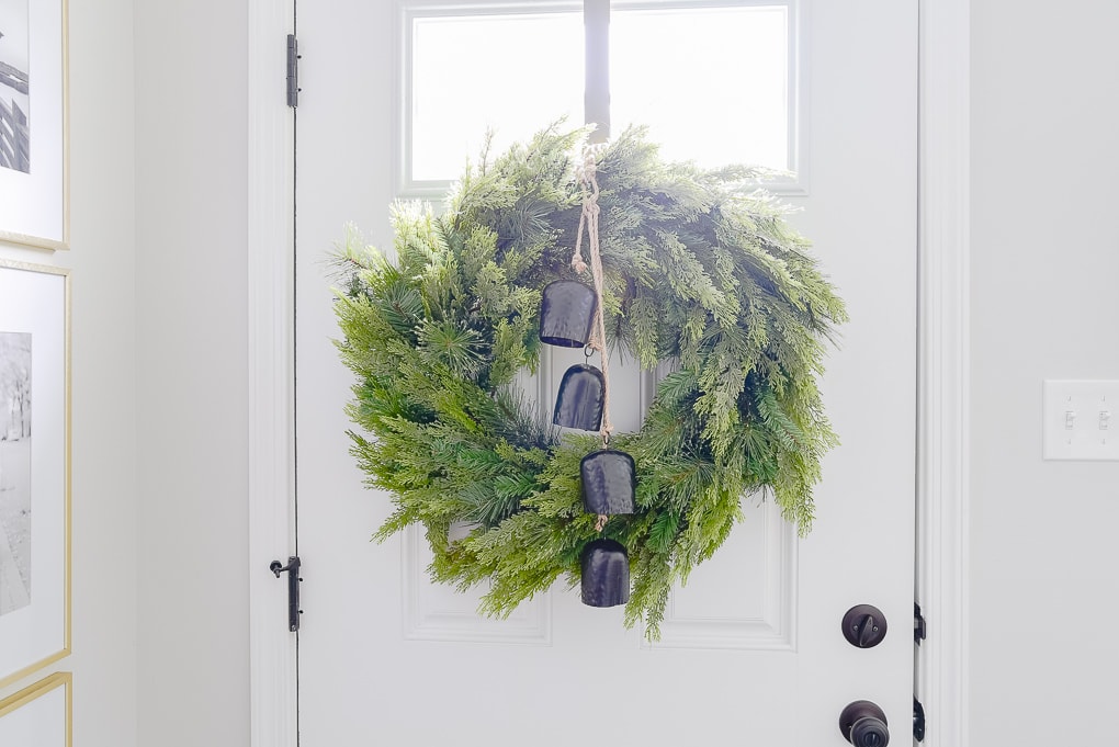 mcgee and co Christmas greenery wreath on door with black bells