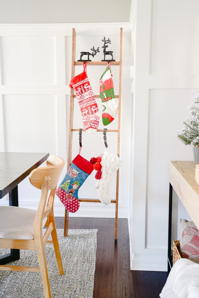 modern classic Christmas stocking ladder with four knitted Christmas stockings hung