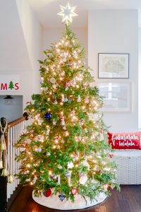 fresh Christmas tree decorated in modern classic living room with family ornaments