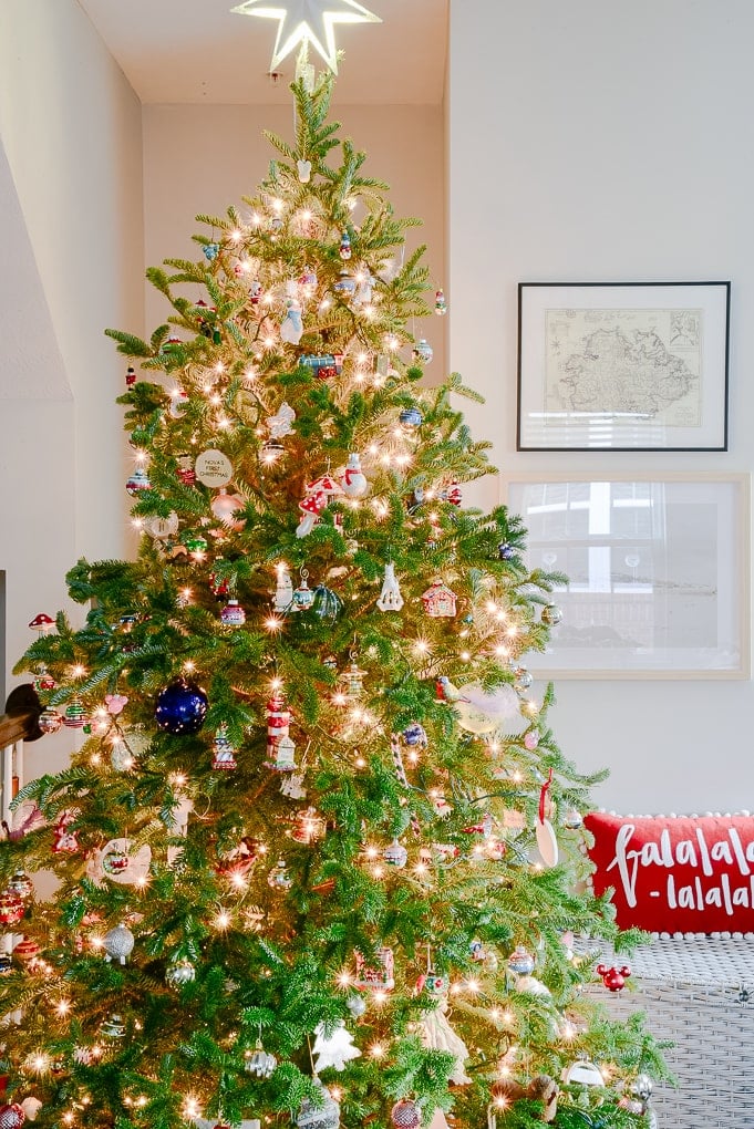 fresh Christmas tree decorated in modern classic living room with family ornaments