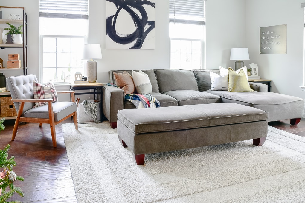 gray sectional couch with natural color throw pillow in modern classic living room decorated for Christmas