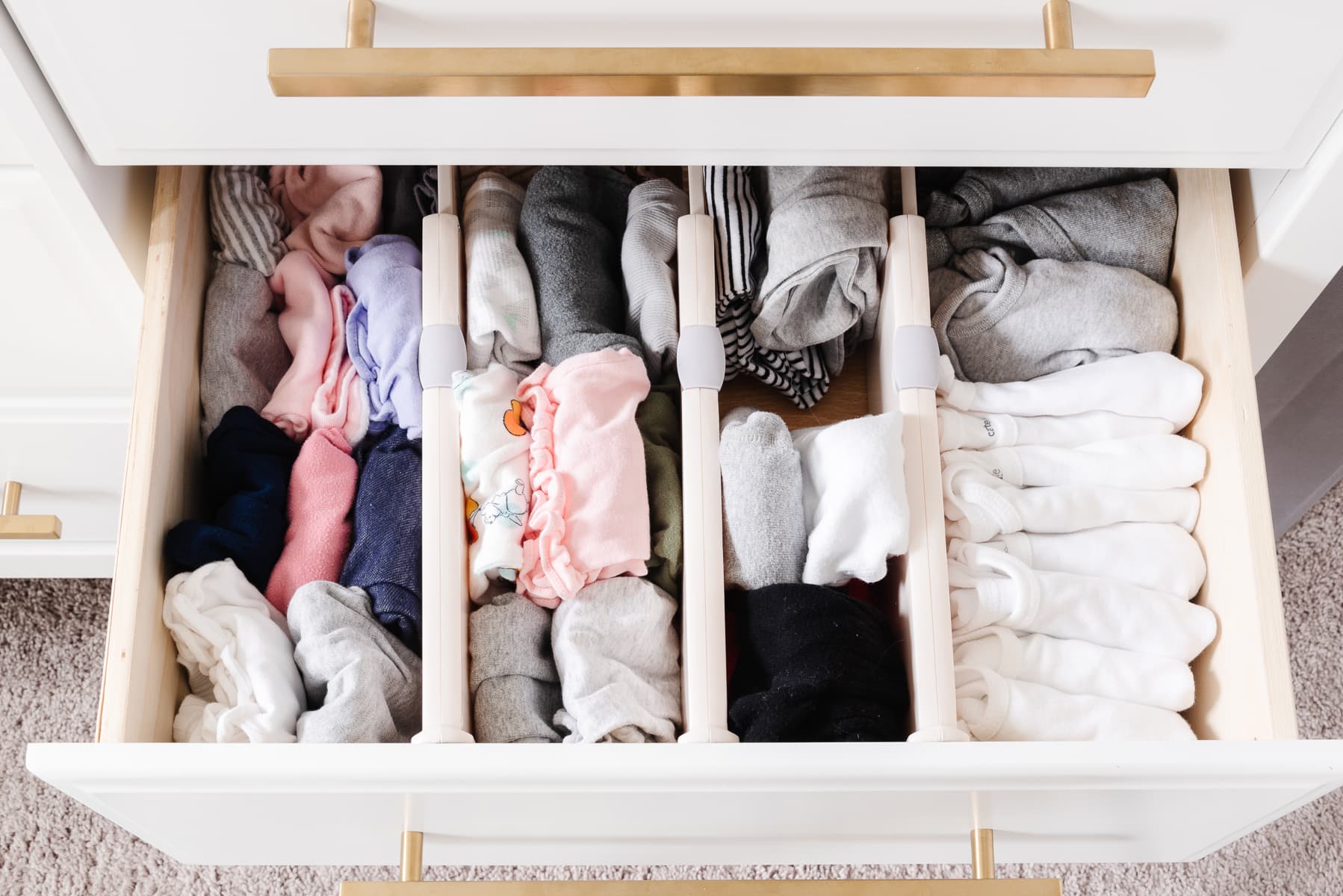 baby clothes organized in drawer with drawer dividers