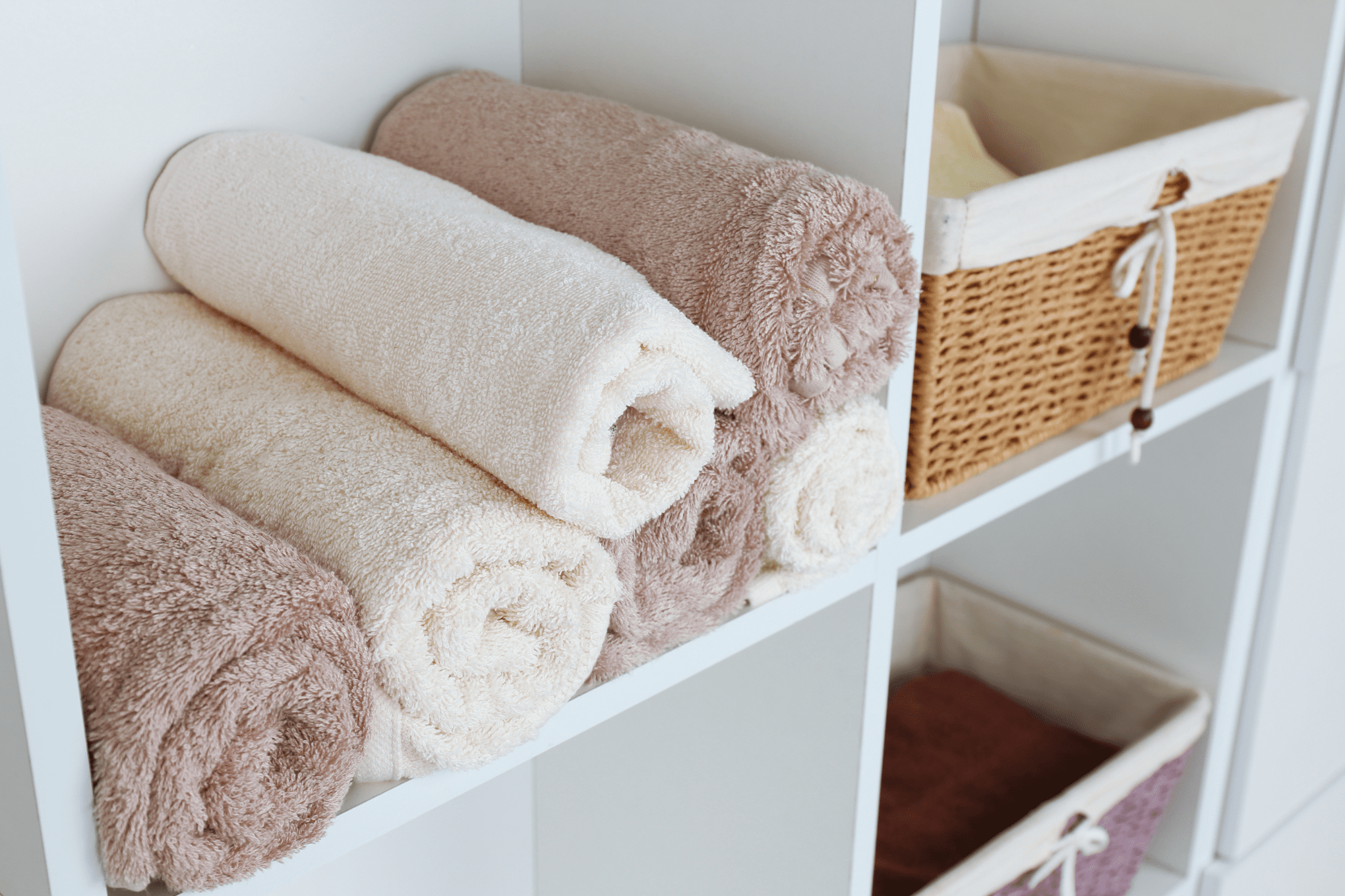 bath towels rolled on shelf in closet